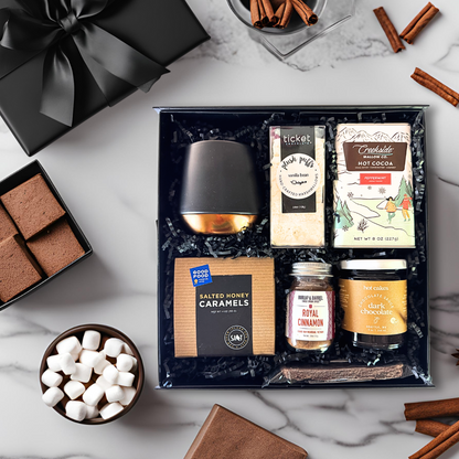 The executive cocoa gift box features luxury high quality items made in washington that in clude, cocoa mix, a doulbe walled ceramic black mug with copper base, plush puffs artisan marshmallows, royal cinnamon, salted honey caramels, chocolate biscotti an dark chocolate sauce.