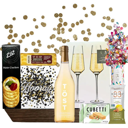 Lets Celebrate gift basket comes in a wooden tray with cheese, crackers, white tea, wafer cookies, nuts, party popper, napkins and champagne flutes.  Apple Blossom Gift Baskets