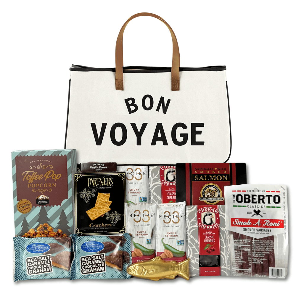 "bon voyage" retirement canvas tote filled with travel snacks like popcorn, nuts, chocolates, pepperonis and snacks made in Washington.