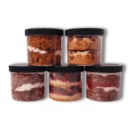 Gourmet Cake Jars – Handcrafted Desserts – A delicious assortment of handmade cake jars, each equivalent to 2.5 to 3 cupcakes, featuring layers of moist cake and creamy frosting—perfect for a birthday gift, dessert lover, or sweet treat on the go.