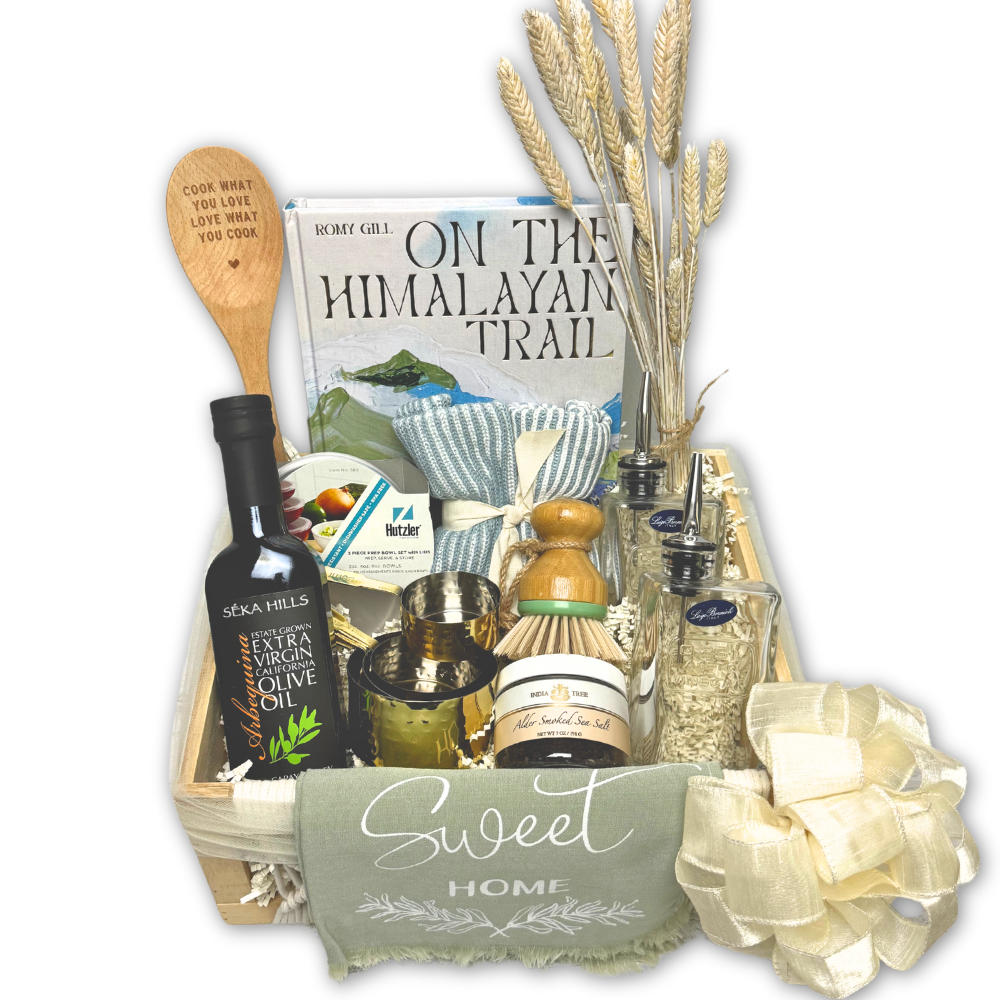 custom chef inspired kitchen themed gift basket with a cookbook, olive oil, dish towels, mixing utensils and other kitchen gadgets and snacks that was assembled by hand in Washington