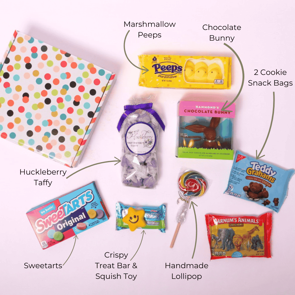 Flat lay of Easter candy gift box, showcasing all included treats: a Hammond’s chocolate bunny, marshmallow Peeps, SweetTarts, lollipops, saltwater taffy, Teddy Grahams, and more—perfect for a springtime surprise.