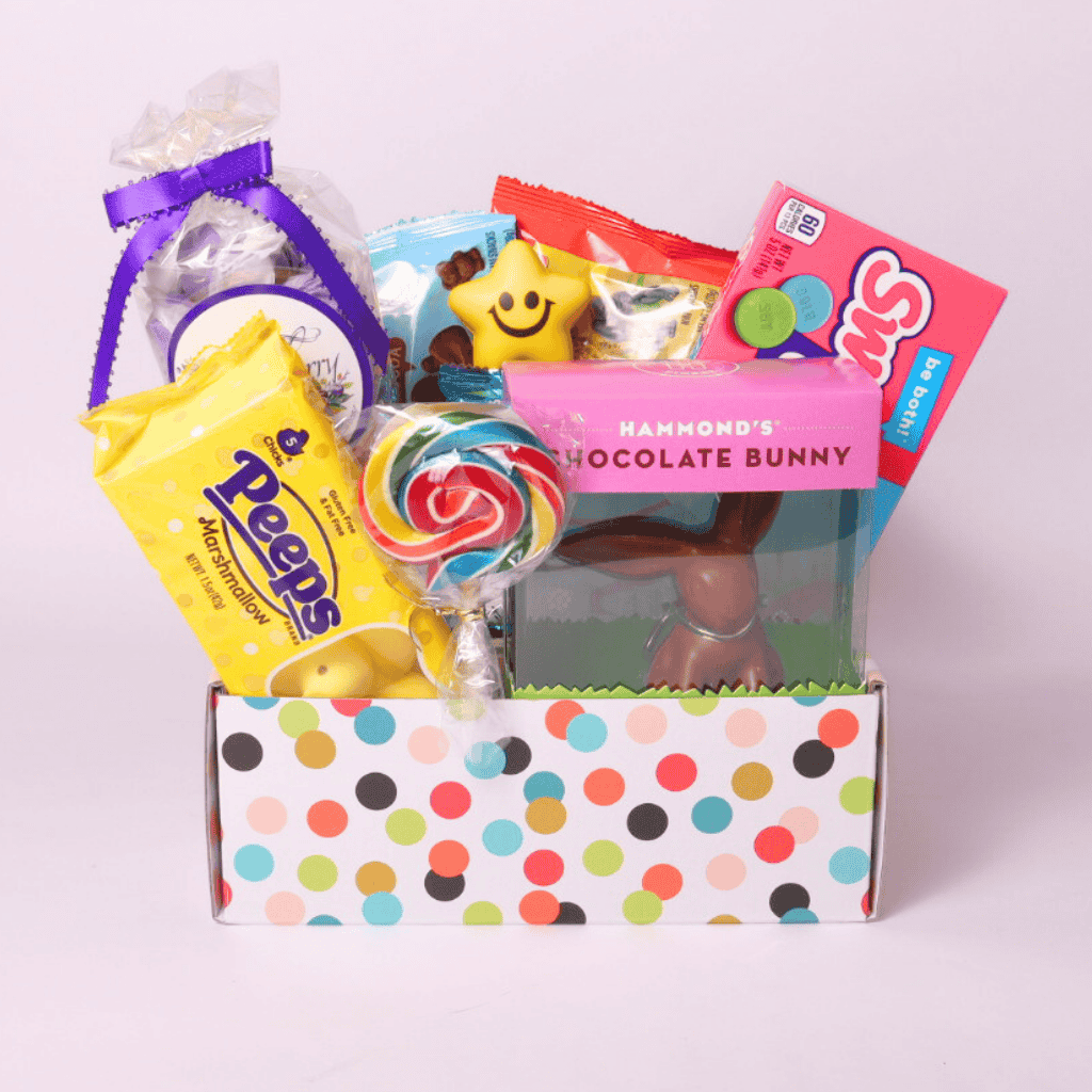 Bright and cheerful Easter snack box with pastel packaging, featuring a delicious selection of chocolates, taffy, cookies, and candies for a festive holiday gift.