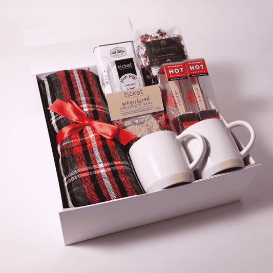 Luxurious Christmas gift box featuring a plaid throw, mugs, and festive treats, perfect for client gifts or as an elegant employee gift. Packaged in a soft-touch gift box with magnetic closure for a premium presentation.