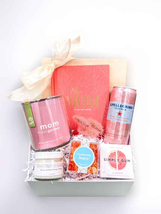 love you mom gift box for mom with pink items including: my mom gift book, mom flower garden, sparkling water, moisturizer, champagne gummy bears and grapefruit gum all in a soft close gift box.  Apple Blossom Gift Baskets