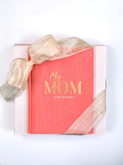 the love you mom gift box come in a signature soft close Apple Blossom Gift Baskets white box with the "my mom" interactive book on the outside and wrapped with a hand tied satin bow