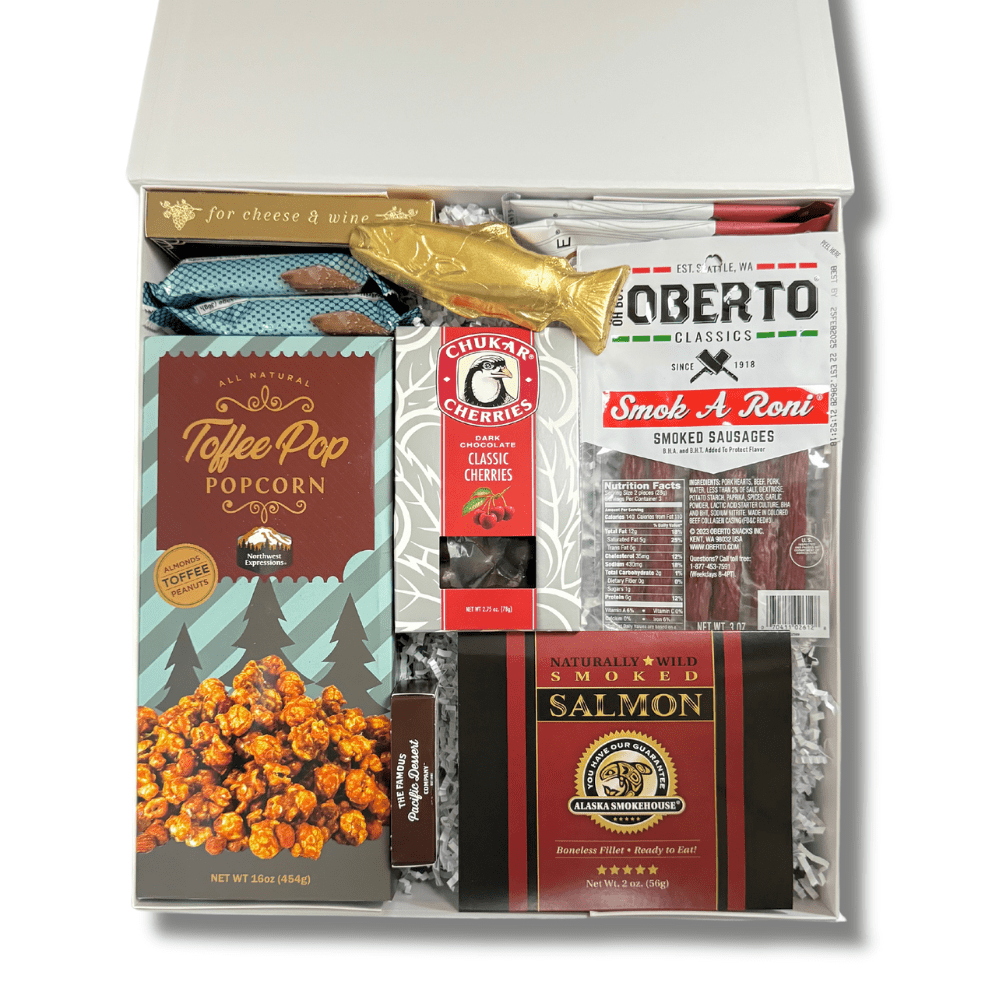 made in washington corporate gift box with local snacks caramel corn, pepperoni sticks, smoked salmon, solid chocolate salmon, smoked almonds, chocolates, crackers and more.