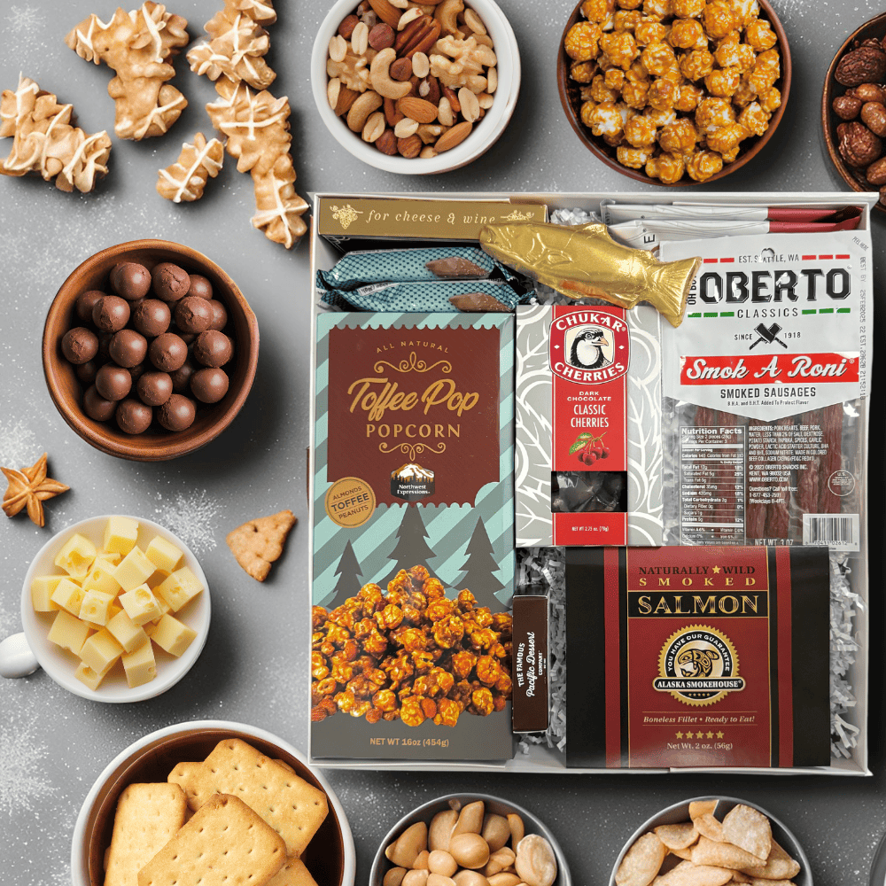 made in washington gift box with local snacks caramel corn, pepperoni sticks, smoked salmon, solid chocolate salmon, smoked almonds, chocolates, crackers and more.