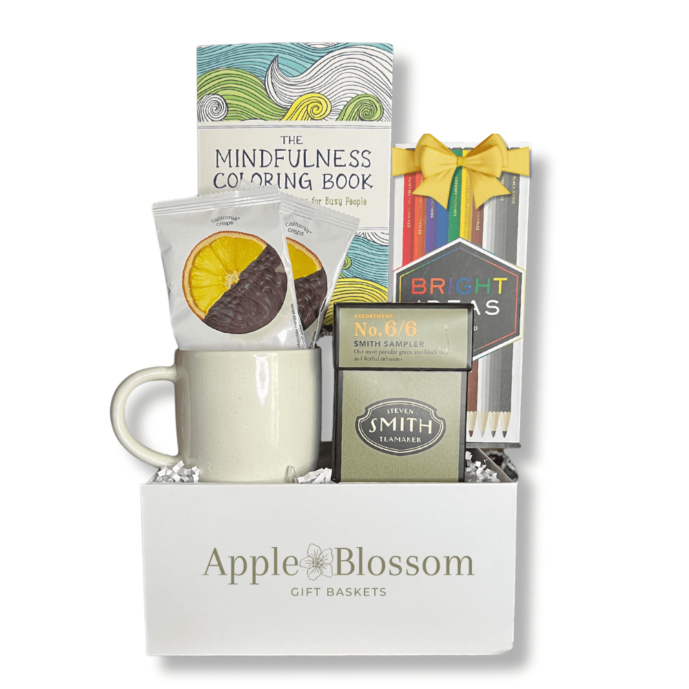 thoughtful and mindful gift box with mindfulness adult coloring book, coloring pencils, tea, ceramic mug and crispy chocolate oranges.  A great gift box to relax by Apple Blossom Gift Baskets