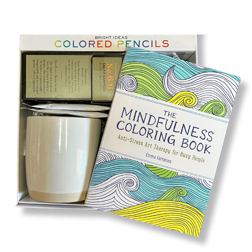 thoughtful and mindful gift box with mindfulness adult coloring book, coloring pencils, tea, ceramic mug and crispy chocolate oranges.  A great gift box to relax by Apple Blossom Gift Baskets