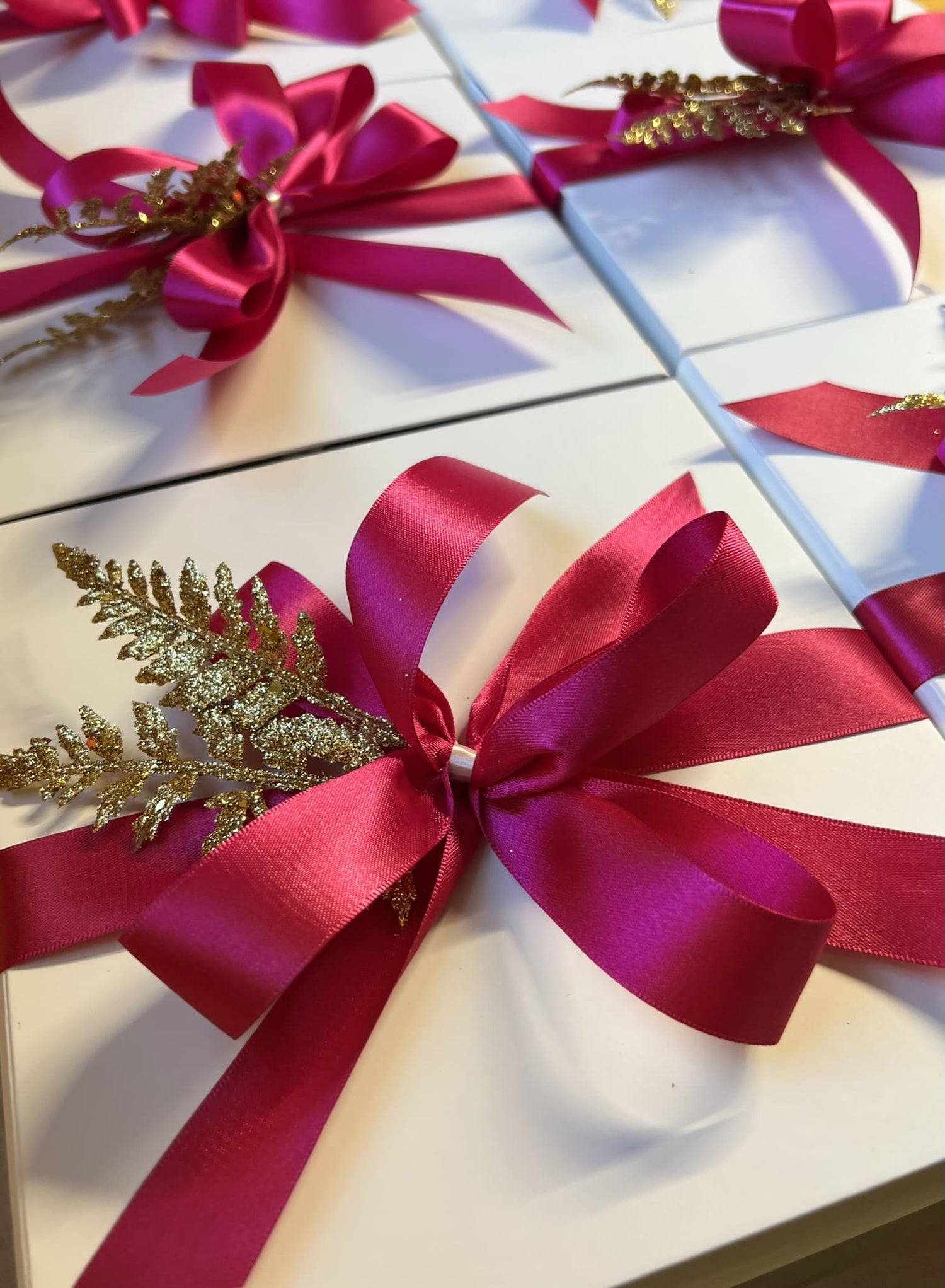 mothers day gift boxes with pink satin bows and gold accents