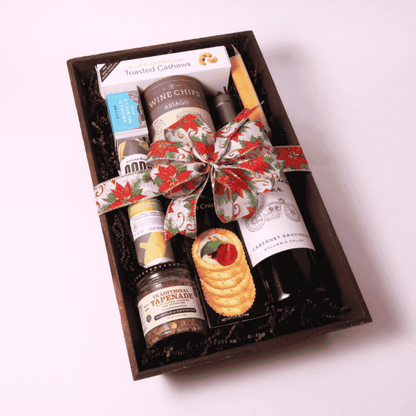 Luxurious Pacific Northwest gift basket on a wooden tray with premium snacks like uncured salami, smoked cheese, sparkling spritz, and cashews; a memorable client gift.