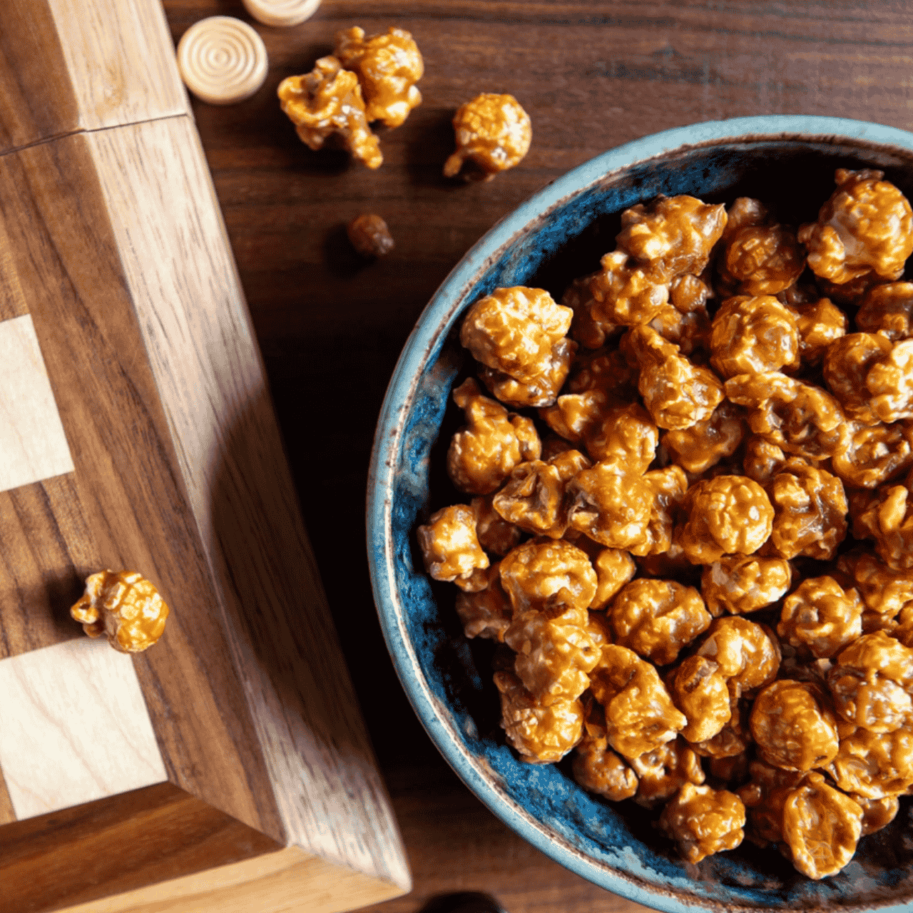 Toffee-covered popcorn in a resealable canister, featuring handcrafted, all-natural, gluten-free toffee popcorn with almonds and petite peanuts made by Northwest Expressions in Washington State—perfect for gourmet gift baskets or family treats.