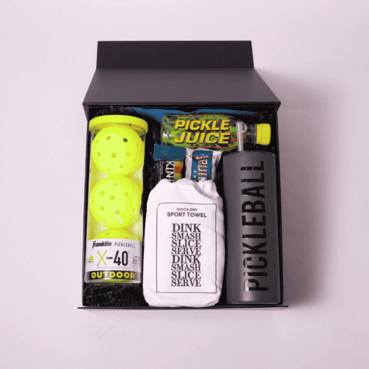 Ultimate pickleball gift set for players, including pickleball tumbler, quick-dry towel, Franklin X-40 balls, and protein bars, in a beautifully wrapped signature gift box.