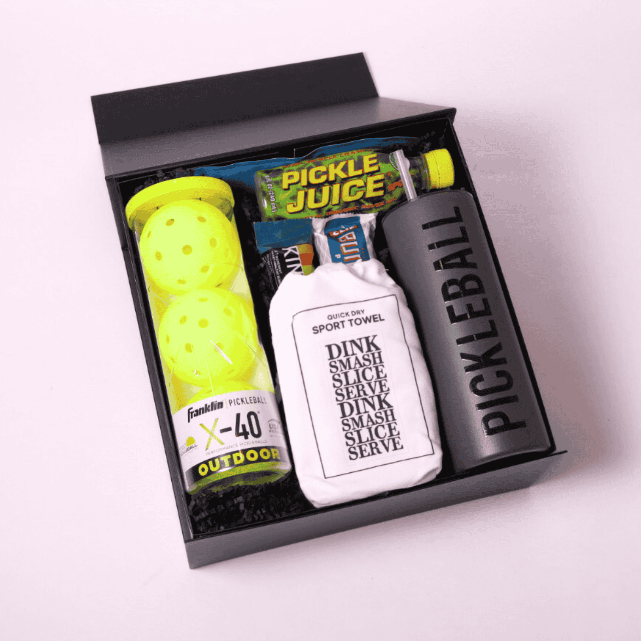 Fun pickleball-themed gift box with essentials like Franklin X-40 balls, pickle juice, and sports towel, ideal for the avid pickleballer or beginner player alike.