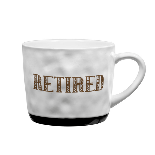 ceramic white mug with gold letters that says "retired"