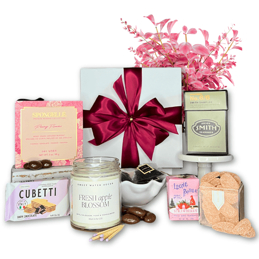 self care gift box with body buffer, wafer cookies, tea, candies, candle and mints