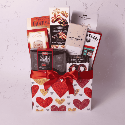 Valentine's snack box featuring handcrafted treats, like sea salt caramels, popcorn, and organic pancake mix. A thoughtful care package for her, kids, or anyone who loves delicious surprises. Perfect for Valentine's Day or as a gift basket.