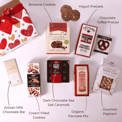 
Flat lay of a Valentine's Day gift box, showcasing delicious treats made in WA: chocolate brownie cookies, gourmet popcorn, yogurt pretzels, dark chocolate caramels, milk chocolate bar, pancake mix, and more. Perfect as a college care package, snack box, or thoughtful Valentine's gift