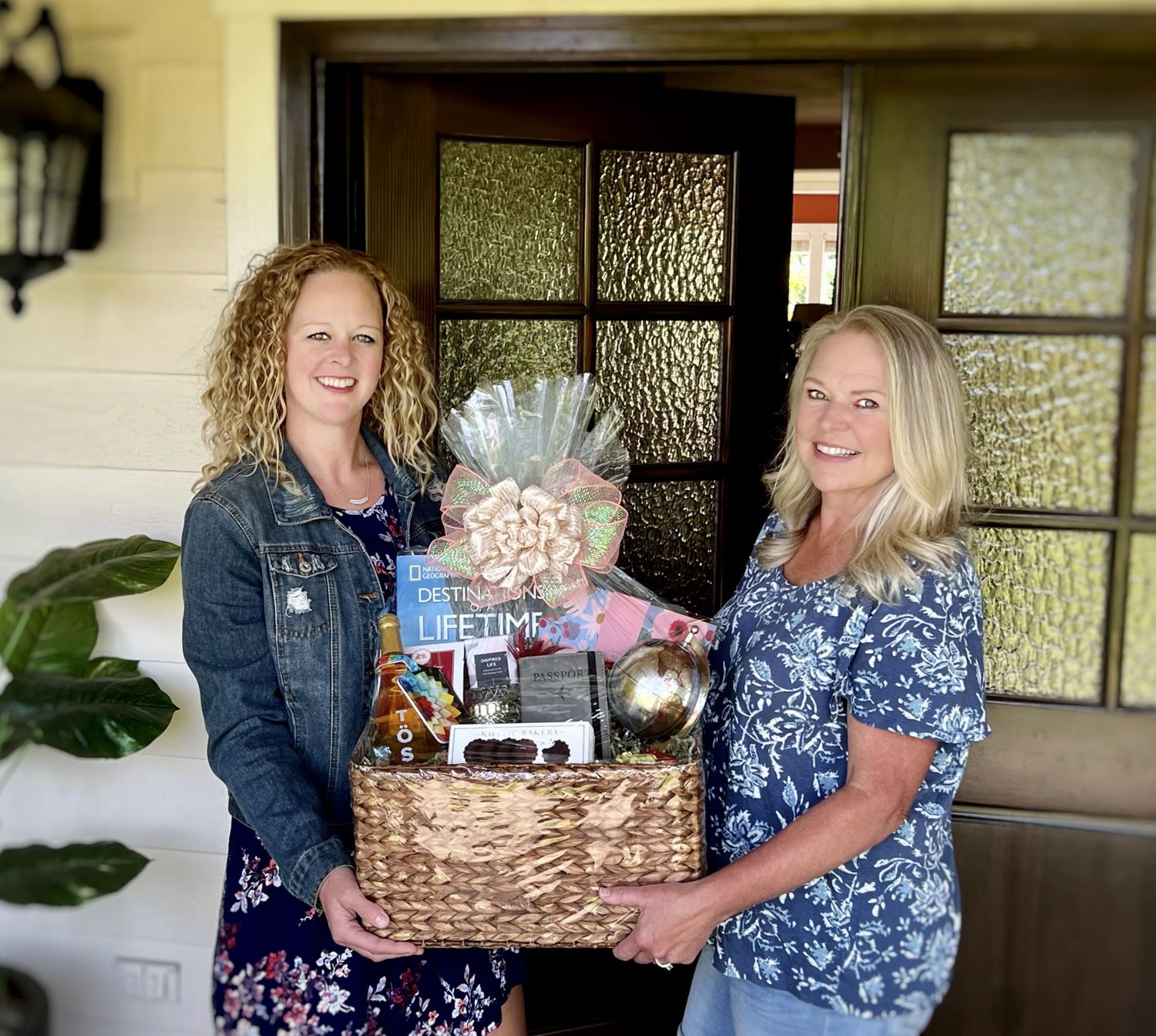 veronica and lisa holding a custom designed gift basket made in Washington