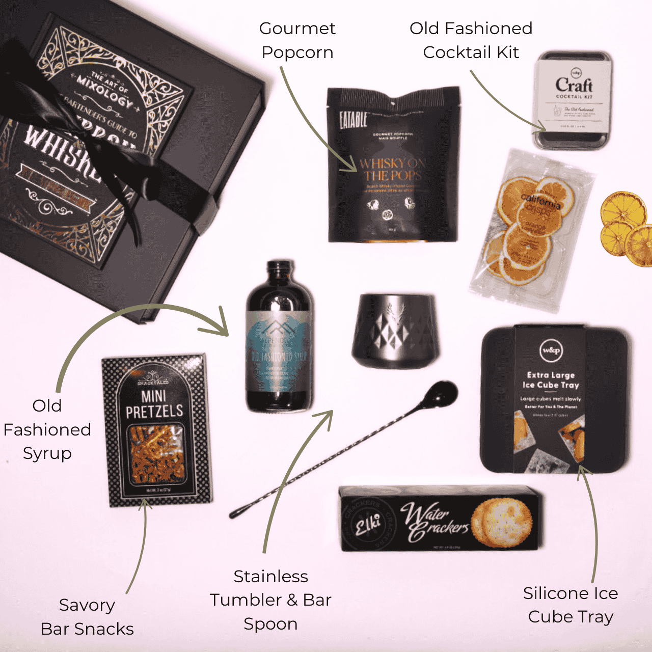 Flat lay of the whiskey-themed gift box contents, featuring Alpenglow Old Fashioned Cocktail Syrup handcrafted in Washington, alongside whiskey popcorn, a tumbler, ice mold, cocktail kit, and more.